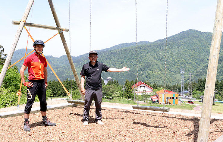 あわすのスキー場に設置された巨大ブランコ。利用を呼びかける佐藤代表（左）と松井支配人